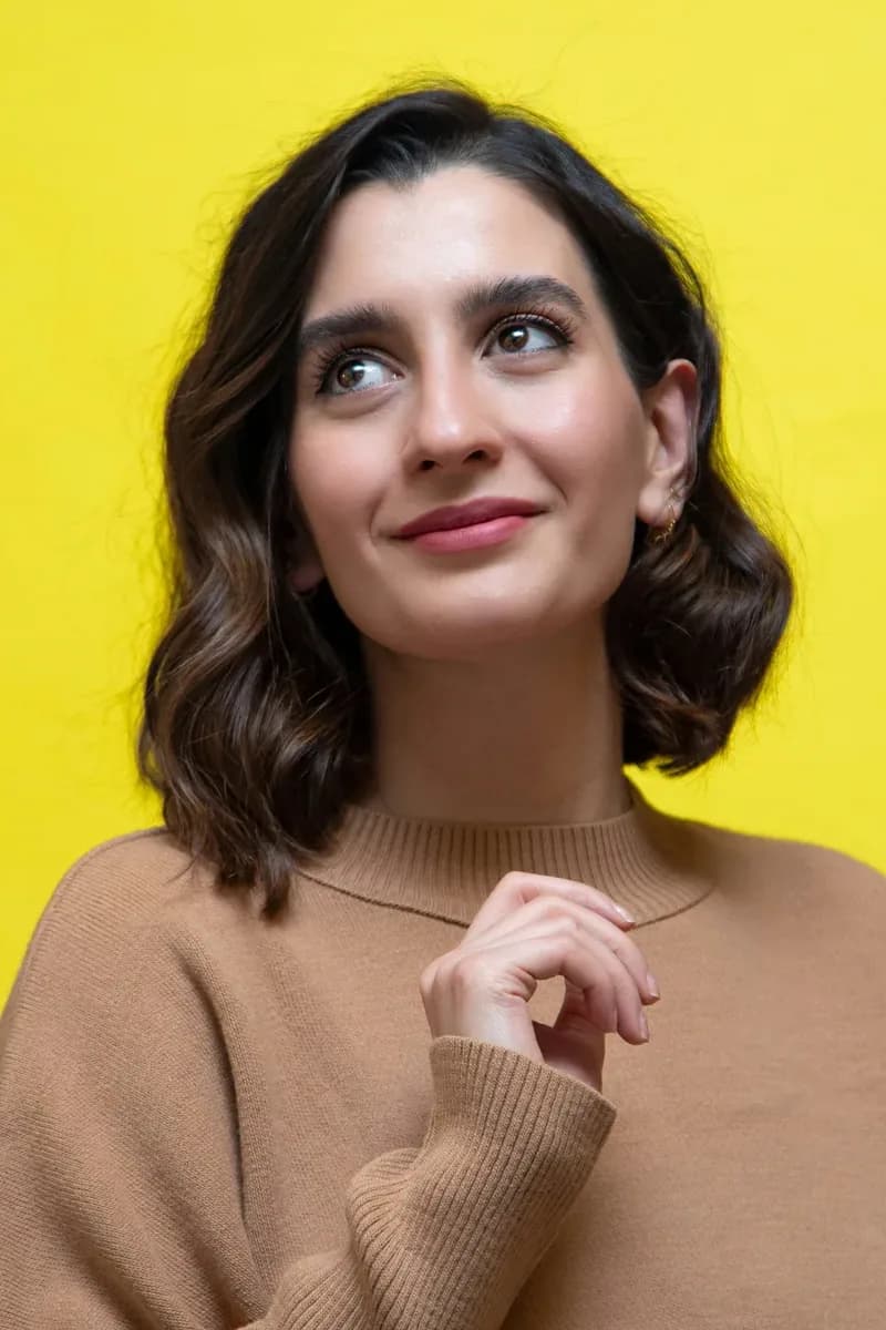 Wavy mid-length to long sleek straight hair